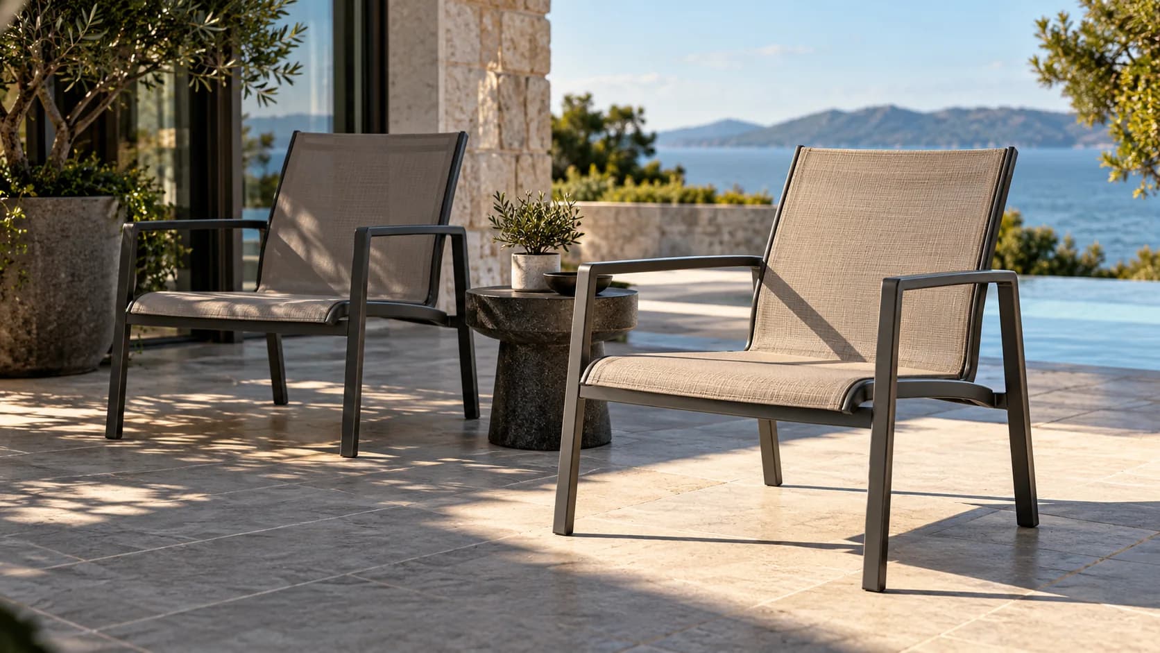 Illustrative scene of two outdoor mesh sling chairs in sunlight and partial shade
