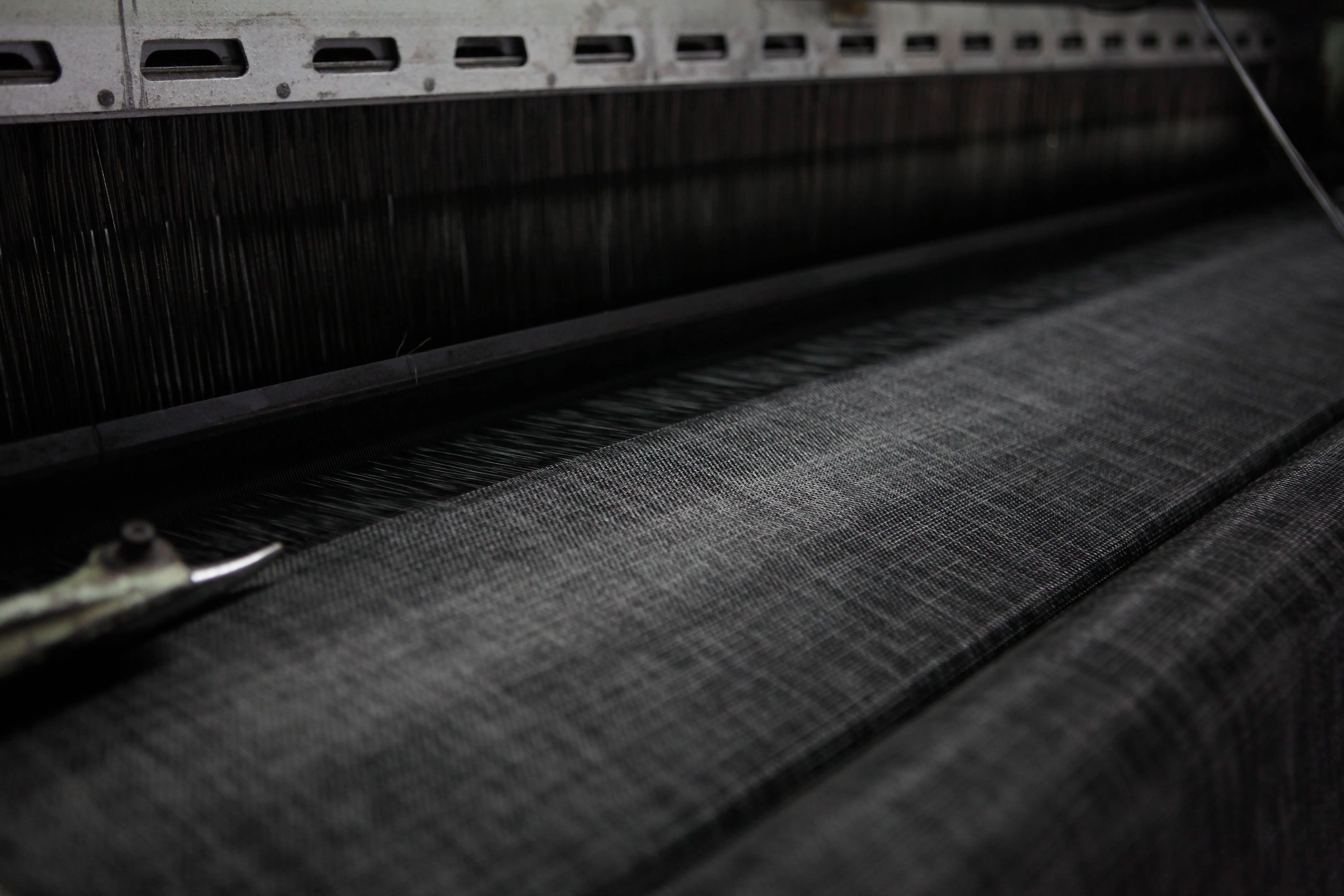 AOLEADER woven fabric moving through a textile weaving machine during production